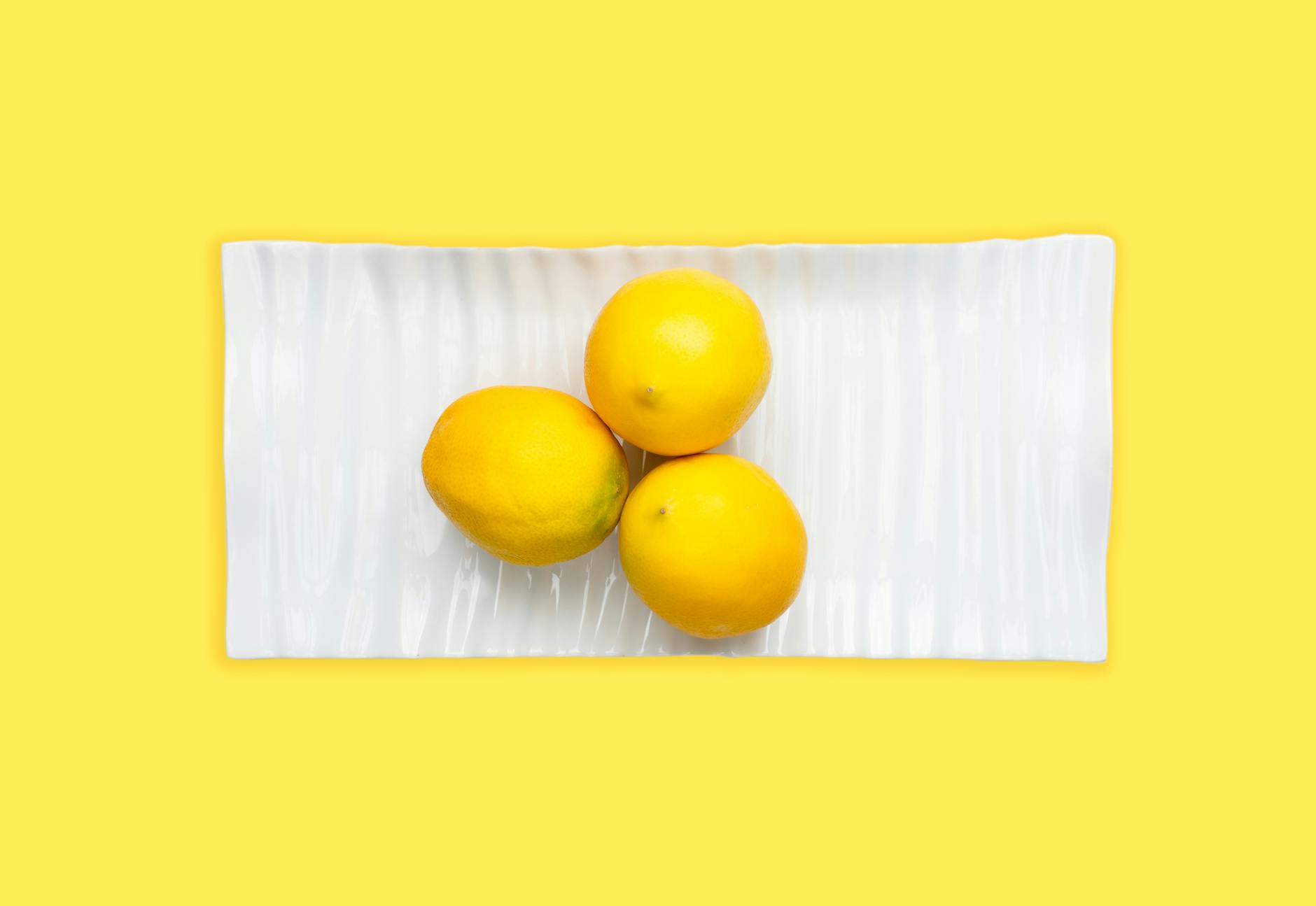 Vibrant display of clitoral vibrators and adult toys arranged on a bright yellow surface