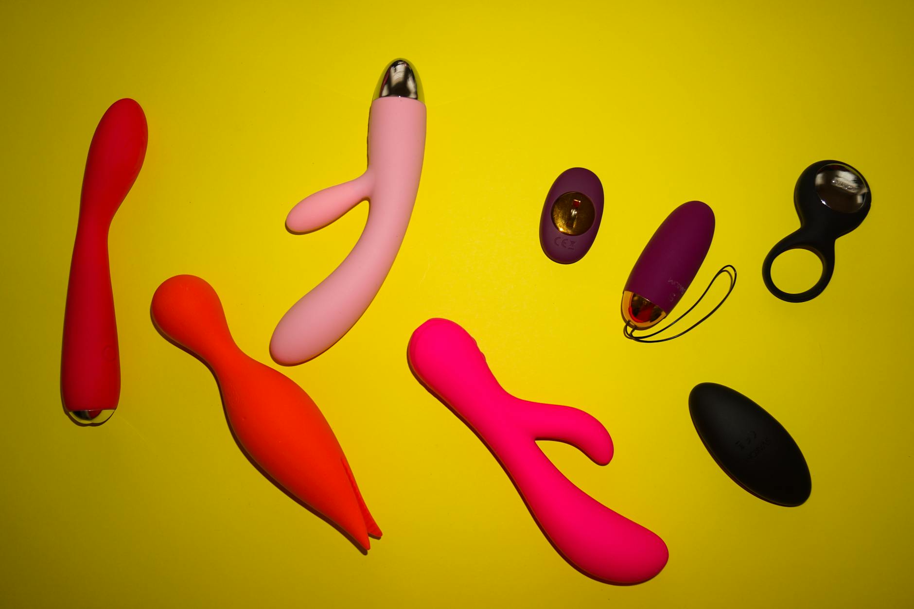 Vibrant sex toys on a bright yellow background