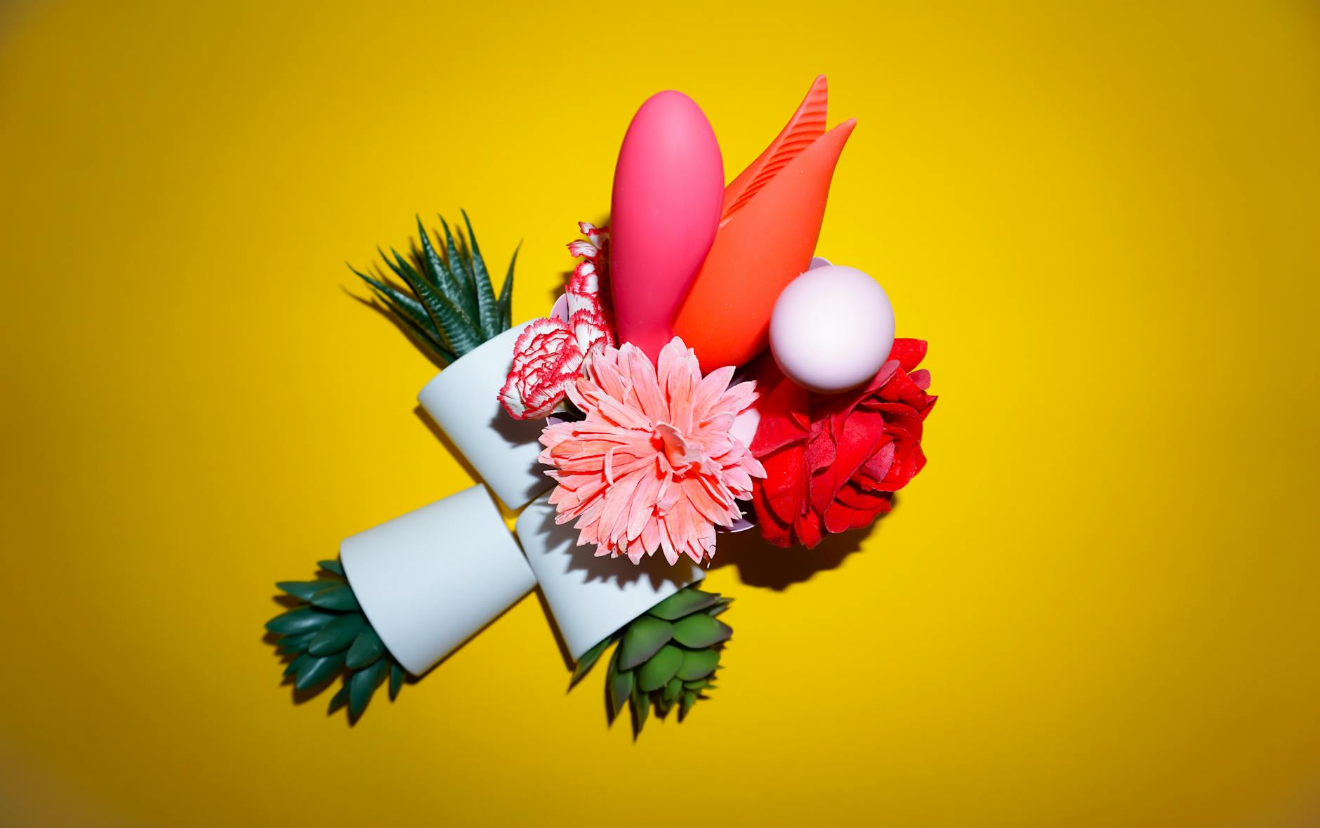 A vibrator held in hand against a minimalist purple backdrop, showcasing modern sensuality